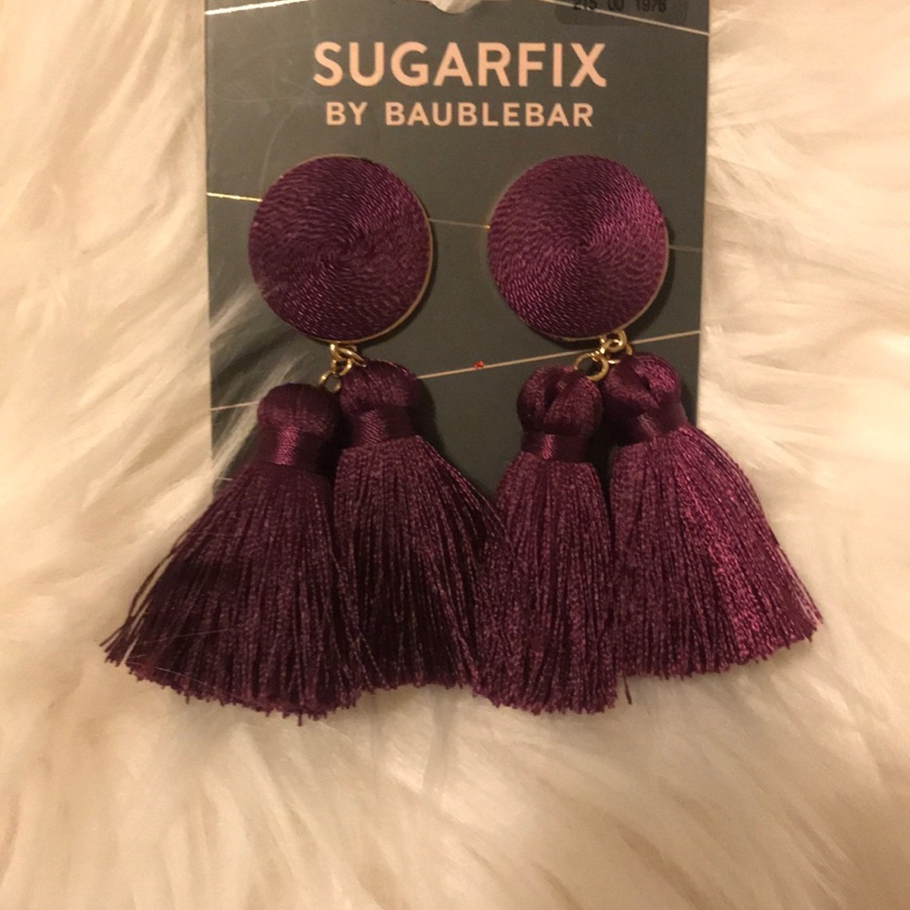 Purple tassel earrings.